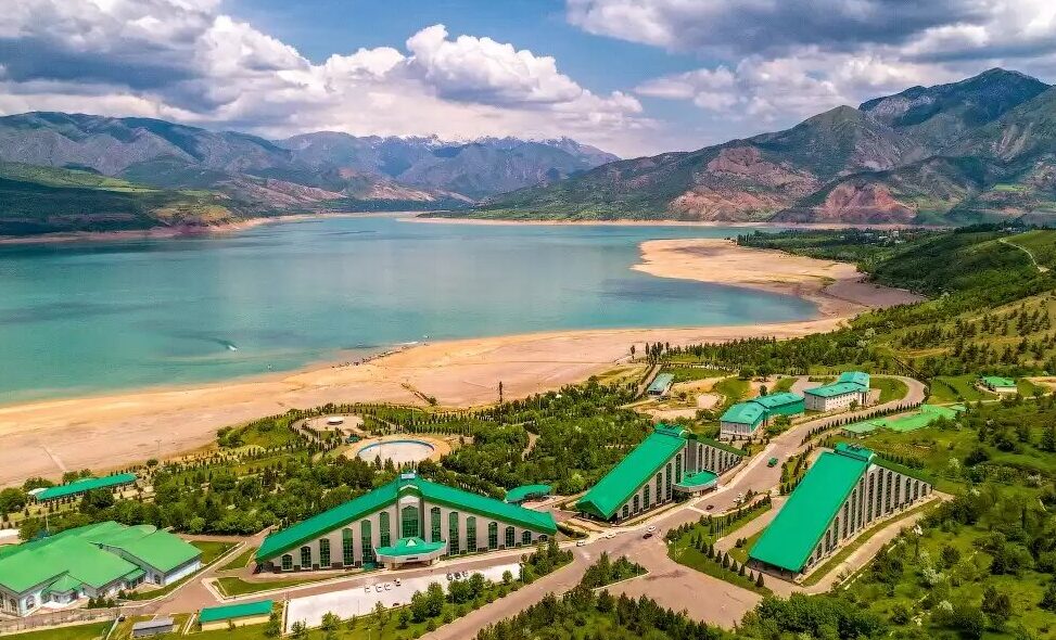 recreational buildings and facilities in front of Charvak lake with site and mountains in the backgound, blue sky with white and grey clouds